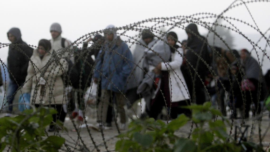 People cross the border from Greece into Macedonia near the southern Macedonian town of Gevgelija, early Saturday, Nov. 14, 2015. (AP)