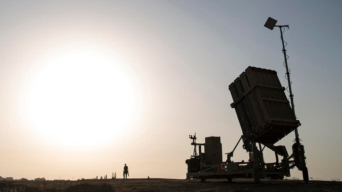 An Israeli soldier walks next to an Iron Dome rocket defense battery near the southern city of Sderot, Israel. (AP)