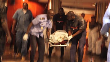 Mali security personal carry the body of a victim inside the Radisson Blu hotel after an attack by gunmen on the hotel in Bamako, Mali, Friday, Nov. 20, 2015. (Reuters)