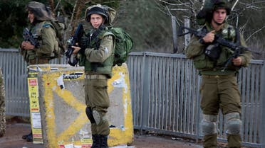 Israeli soldiers stand guard at a bus stop after near the Palestinian town of Nablus in the occupied West Bank. (File photo: AP) 