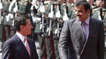 Mexico's President Enrique Pena Nieto and Qatar's Emir Sheikh Tamim Bin Hamad Al-Thani review the honour guard during an official welcoming ceremony for al-Thani, in Mexico City. (Reuters)