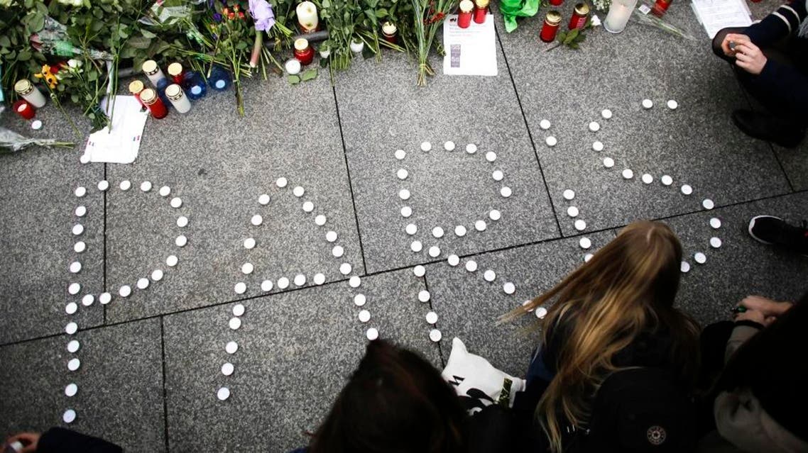 Young women have formed the word Paris with candles to mourn for the victims killed in Friday's attacks in Paris, France, in front of the French Embassy in Berlin, Saturday, Nov. 14, 2015. Multiple attacks across Paris on Friday night have left scores dead and hundreds injured.(AP Photo/Markus Schreiber)