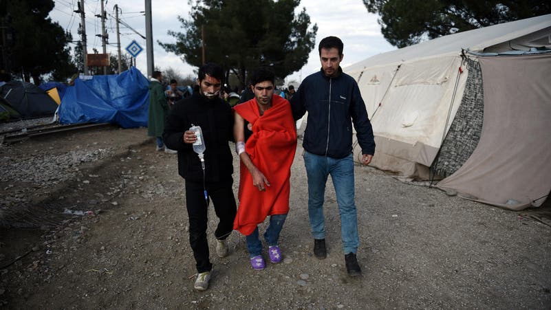 Refugees sew lips together in protest