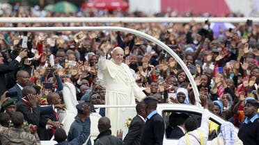 Pope Francis waves to faithful as he arrives for a Papal mass in Kenya's capital Nairobi, November 26, 2015. 