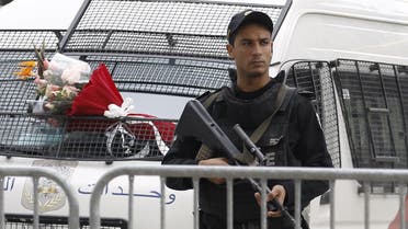 A Tunisian policeman stands guard near the scene of a suicide bomb attack in Tunis, Tunisia November 25, 2015. (AP)