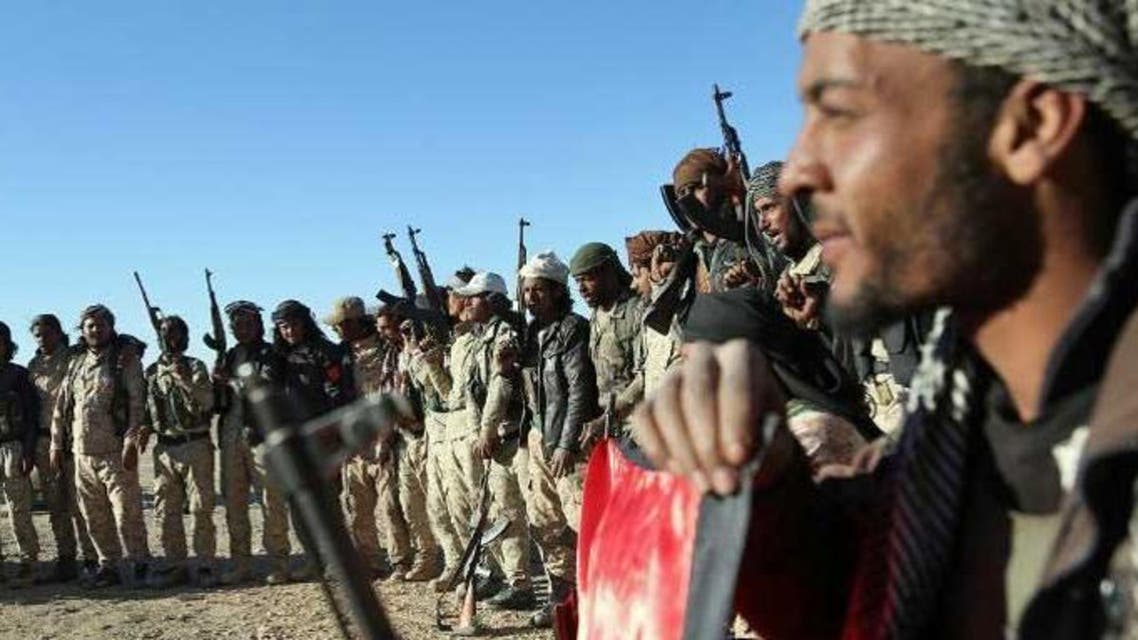 Fighters from the Syrian Democratic Forces (SDF) coalition, which includes Kurds, Arabs and Syriac Christians, gather on the outskirts of the northeastern town of Al-Hol, in the Syrian Hasakeh province after they took control of the area from IS group militants. (AFP)