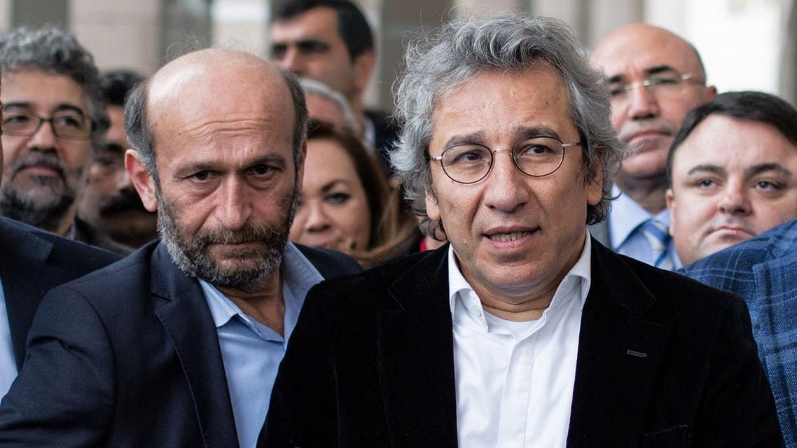 Can Dundar, the editor-in-chief of opposition newspaper Cumhuriyet, right, and Erdem Gul, the paper's Ankara representative, left, speak to the media outside a courthouse in Istanbul. (AP)