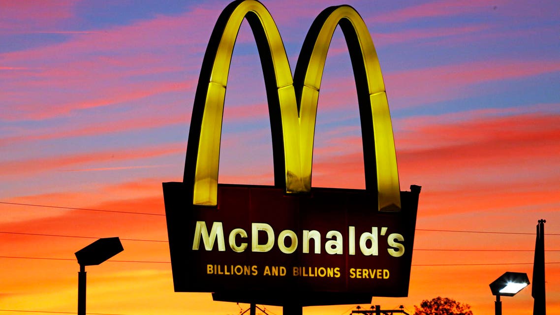 In this Saturday, Oct. 10, 2015, photo, the sun sets behind a McDonald's in Ebensburg, Pa. McDonald's hopes it has a catchy, new deal that will be as hugely popular as its Dollar Menu.