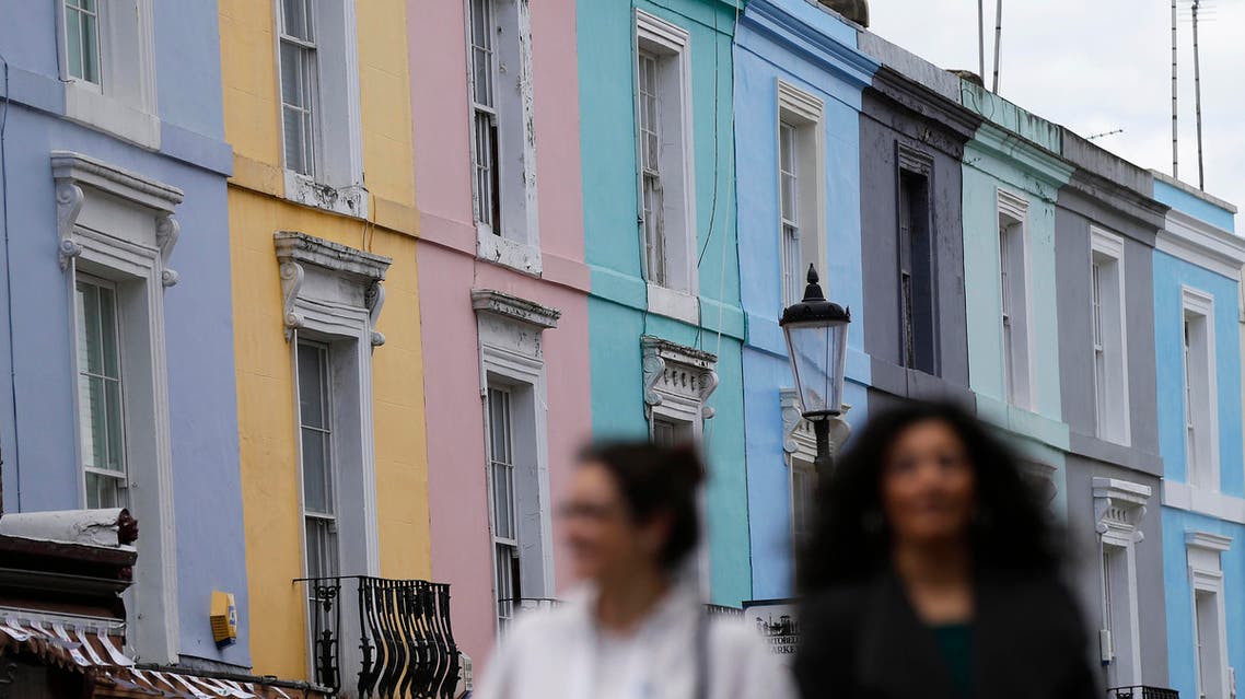 Pedestrians walk past a row of houses in London, Britain June 3, 2015. (Reuters)