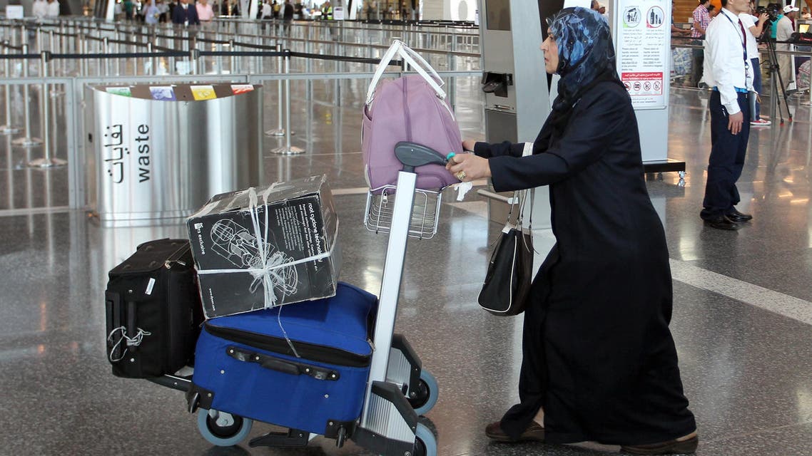 A Qatari passenger walks to the check-in area inside the new Hamad International Airport on the opening day, in Doha, Qatar, Tuesday, May 27, 2014. (AP)