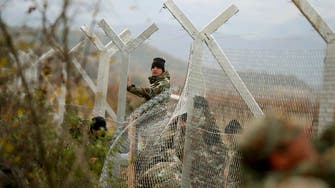 Macedonia erects fence on Greek border to control migrant flow 