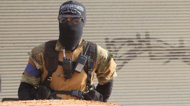A member of al Qaeda's Nusra Front stands behind a vehicle before heading towards his position during an offensive to take control of the northwestern city of Ariha from forces loyal to Syria's President Bashar al-Assad, in Idlib province May 28, 2015. (Reuters)