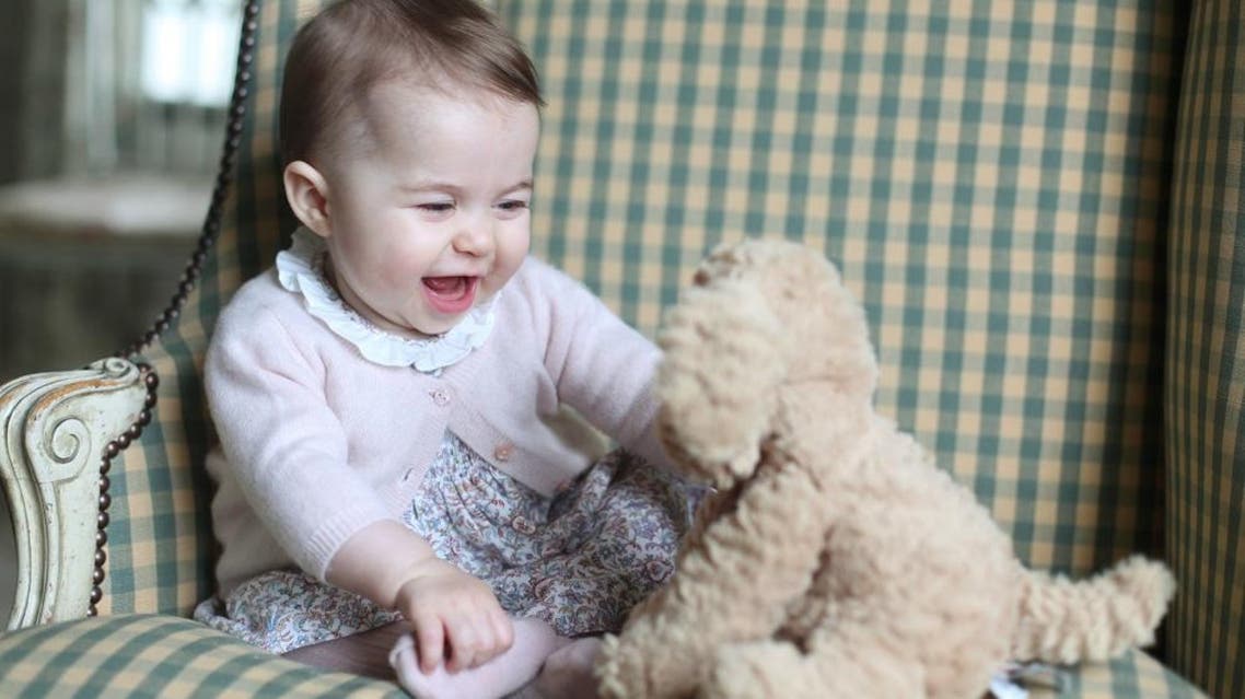 In this undated photo released Sunday Nov. 29, 2015, by Britain's Duke and Duchess of Cambridge, showing Princess Charlotte with her cuddly toy dog, at Anmer Hall in Sandringham, England. Princess Charlotte was born May 2, 2015, and the photo was taken by her mother, Kate Duchess of Cambridge, during November 2015. (Duchess of Cambridge via AP)