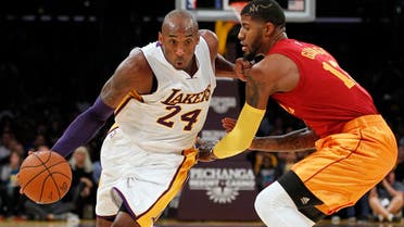Los Angeles Lakers forward Kobe Bryant (24) drives against Indiana Pacers forward Paul George. (File photo: AP)