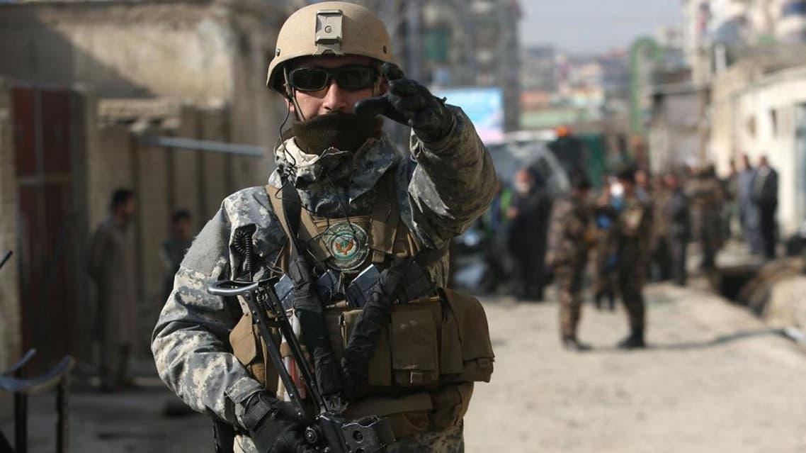 Afghan security forces inspect the site of a suicide attack in Kabul, Afghanistan, Saturday, Nov. 28, 2015. Afghanistan's election commission says one of its officials escaped unharmed after a suicide bomber targeted his vehicle in the capital, Kabul, killing his bodyguard and wounding his driver. (AP Photo/Rahmat Gul)