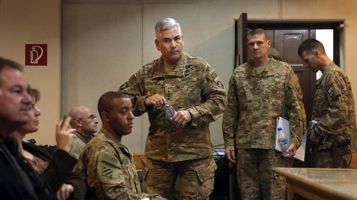 Commander of U.S. and NATO forces in Afghanistan, General John F. Campbell, center, arrives for a press conference at the Resolute Support Headquarters in Kabul, Afghanistan, Wednesday, Nov. 25, 2015. (AP Photos/Massoud Hossaini, Pool)