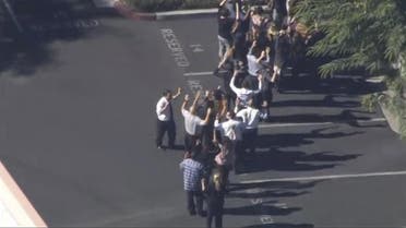 A still image from a video footage courtesy of Nbcla.com shows people lining up as first responders respond to shooting at the California Department of Developmental Services Inland Regional Center, one of 21 facilities serving people with developmental disabilities, in San Bernardino, California December 2, 2015. Three people were killed and as many as 20 were wounded on Wednesday when at least one person opened fire at a social services agency in the Southern California city of San Bernardino, authorities and a witness said. REUTERS/NBCLA.COM/Handout FOR EDITORIAL USE ONLY. NOT FOR SALE FOR MARKETING OR ADVERTISING CAMPAIGNS. THIS IMAGE HAS BEEN SUPPLIED BY A THIRD PARTY. IT IS DISTRIBUTED, EXACTLY AS RECEIVED BY REUTERS, AS A SERVICE TO CLIENTS. NO SALES. MANDATORY CREDIT NO RESALES. NO ARCHIVE
