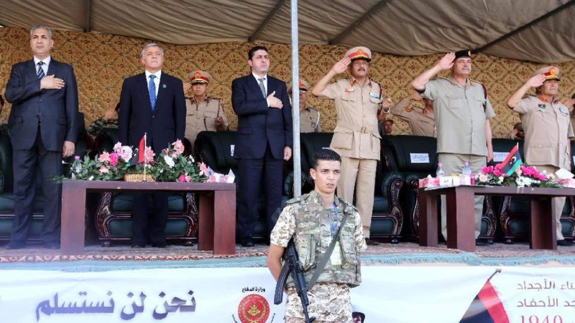 Libya's PM of the self-declared Islamist-backed government in Tripoli, Khalifa Al-Ghweil (C) and head of the General National Congress Nouri Bousahmein (2-L) attend a ceremony in Tripoli, on Aug. 13. (AFP)