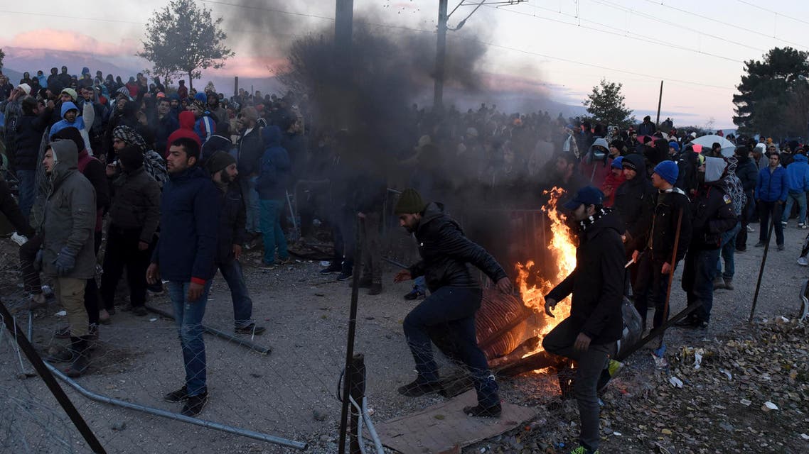 Stranded migrants block the crossing, where refugees pass the Greek-Macedonian border, near the northern Greek village of Idomeni, Thursday, Dec. 3, 2015. (AP)