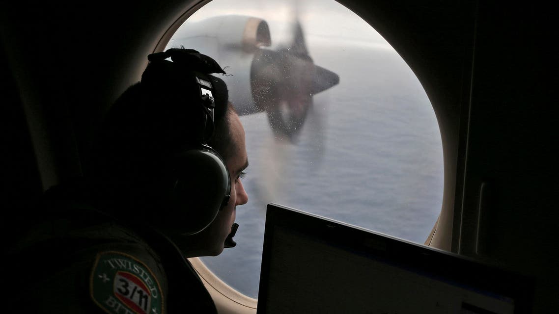 In this March 22, 2014 file photo, flight officer Rayan Gharazeddine on board a Royal Australian Air Force AP-3C Orion, searches for the missing Malaysia Airlines Flight MH370 in southern Indian Ocean, Australia. 