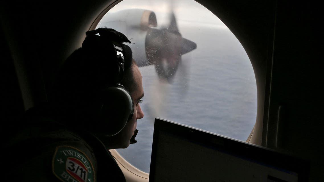 In this March 22, 2014 file photo, flight officer Rayan Gharazeddine on board a Royal Australian Air Force AP-3C Orion, searches for the missing Malaysia Airlines Flight MH370 in southern Indian Ocean, Australia.