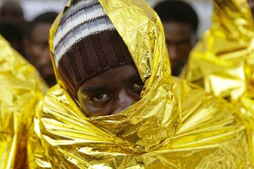 A migrant waits to disembark from a Coast Guard ship in the Sicilian harbour of Messina, Italy. (Reuters)