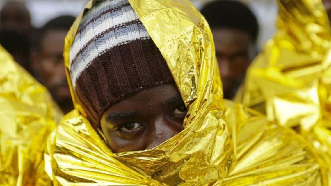 A migrant waits to disembark from a Coast Guard ship in the Sicilian harbour of Messina, Italy. (Reuters)