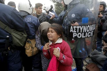 A refugee girl cries after passing through a Greek police cordon before crossing the Greek-Macedonian border near the village of Idomeni. (Reuters)