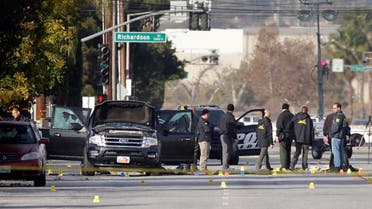 Investigators gather around a Black SUV that was involved in Wednesday's police shootout with suspects, Thursday, Dec. 3, 2015, in San Bernardino, Calif. A heavily armed man and woman dressed for battle opened fire on a holiday banquet for his co-workers Wednesday, killing multiple people and seriously wounding others in a precision assault, authorities said. Hours later, they died in a shootout with police. (AP Photo/Jae C. Hong)