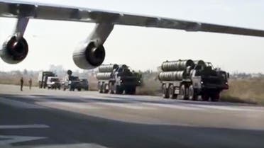 Russian S-400 air defense missile systems travel along the runway at the Hemeimeem air base in Syria, about 50 kilometers (30 miles) south of the border with Turkey. (AP)