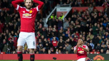 Manchester United's Anthony Martial, right, and Juan Mata react after a missed opportunity during the English Premier League soccer match between Manchester United and West Ham United at Old Trafford Stadium, Manchester, England, Saturday, Dec. 5, 2015. (AP Photo/Jon Super)