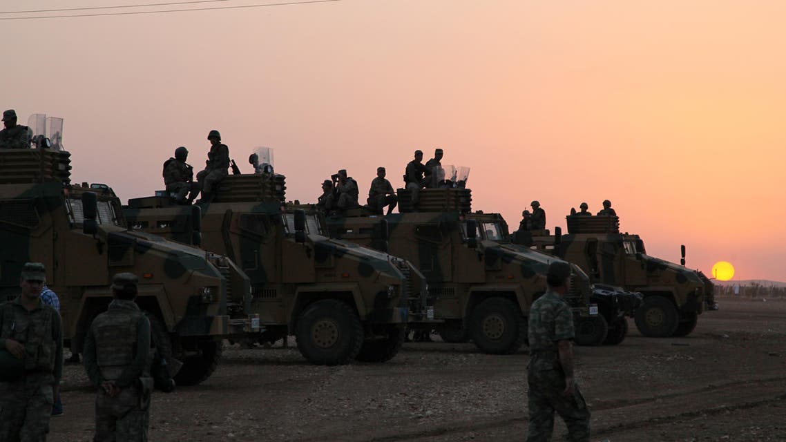 Turkish soldiers in position a few hundred meters from the border line as fighting intensified between Syrian Kurds and the militants of Islamic State around Kobani in Syria, near Suruc, Turkey, late Friday, Oct. 3, 2014.