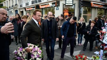 Former governor of California and film star Arnold Schwarzenegger arrives to pay his respects at a memorial outside the Bataclan concert hall on December 5, 2015 in Paris | AFP