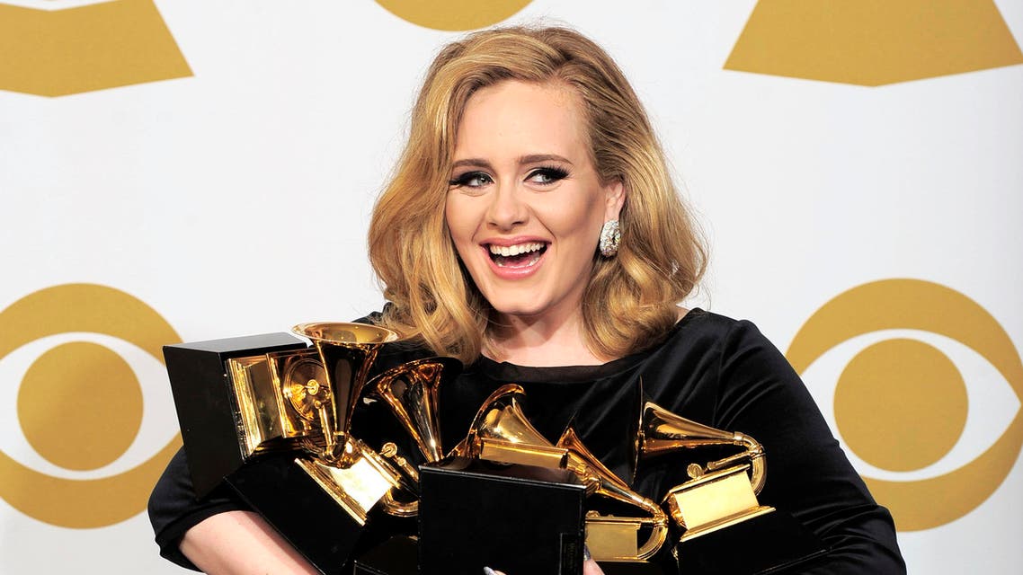 Adele poses backstage with her six awards at the 54th annual Grammy Awards on Sunday, Feb. 12, 2012 in Los Angeles. Adele won awards for best pop solo performance for "Someone Like You," song of the year, record of the year, and best short form music video for "Rolling in the Deep," and album of the year and best pop vocal album for "21." (AP Photo/Mark J. Terrill)