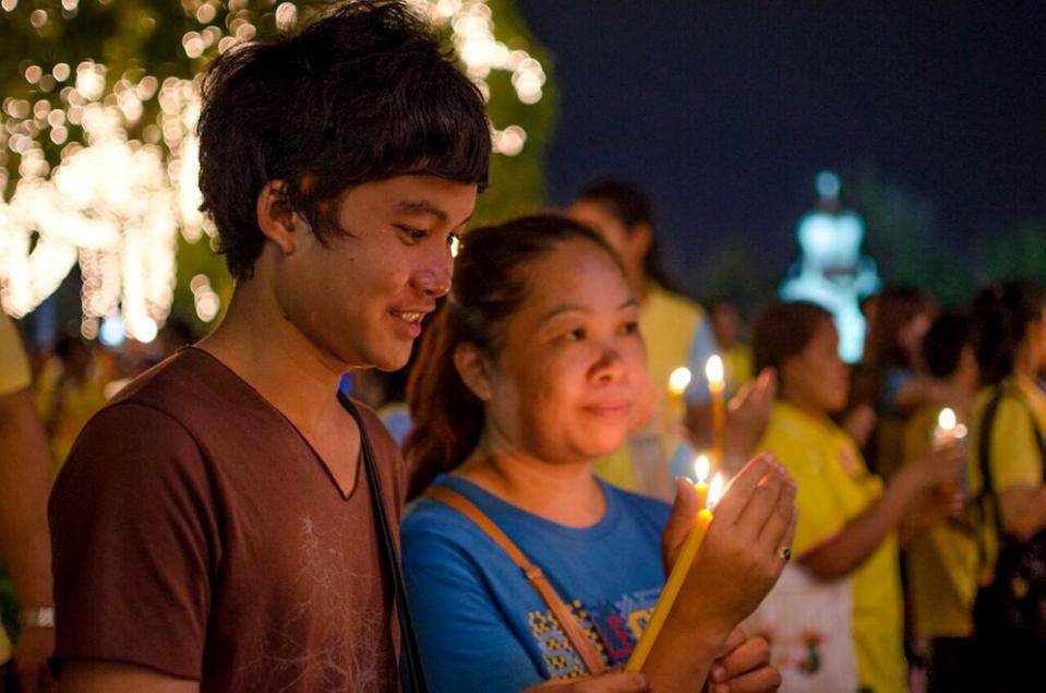 ell-wishers light candles for Thailand's King Bhumibol Adulyadej to mark his 88th birthday in Bangkok, Thailand