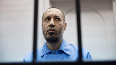  Saadi Muammar Gadhafi, wears a blue jumpsuit behind bars during his trial in the center of Tripoli, Libya, Sunday, Nov. 1, 2015. He is charged with the first-degree murder in 2005 of a former trainer at Tripoli's Al-Ittihad football club. (AP Photo/Mohamed Ben Khalifa)