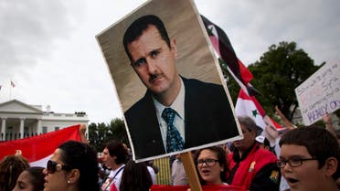 Protesters carry an image of Syrian President Bashar Hafez al-Assad during a demonstration against US military action in Syria, Monday, Sept. 9, 2013.