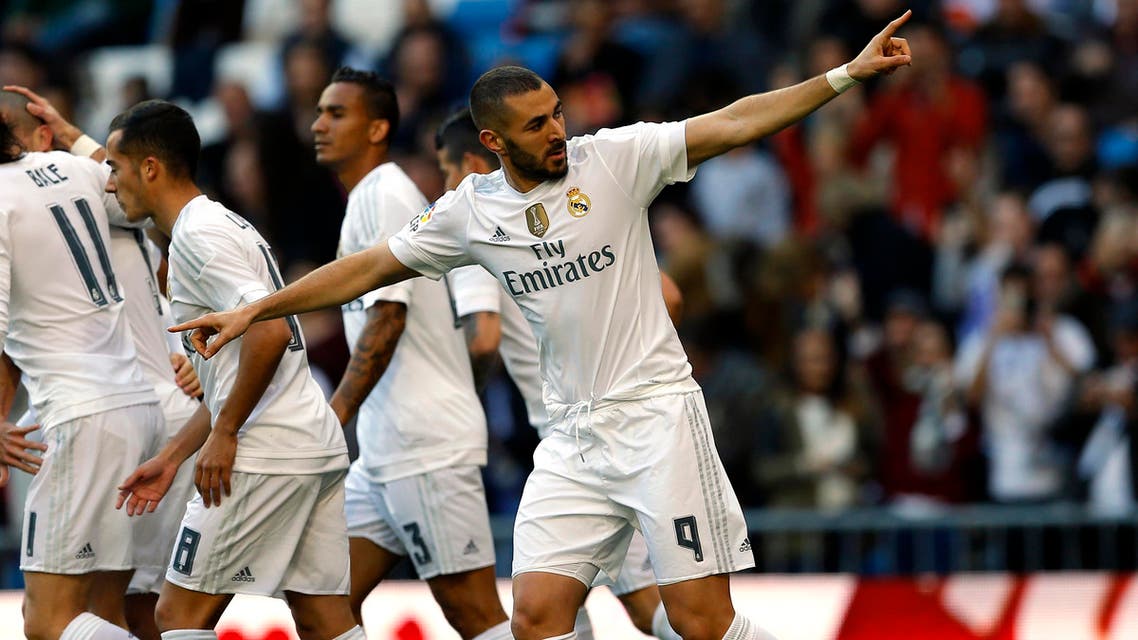 Real Madrid's Karim Benzema, right, celebrates with teammates after scoring the opening goal against Getafe during the Spanish La Liga soccer match between Real Madrid and Getafe at the Santiago Bernabeu stadium in Madrid, Saturday, Dec. 5, 2015. (AP
