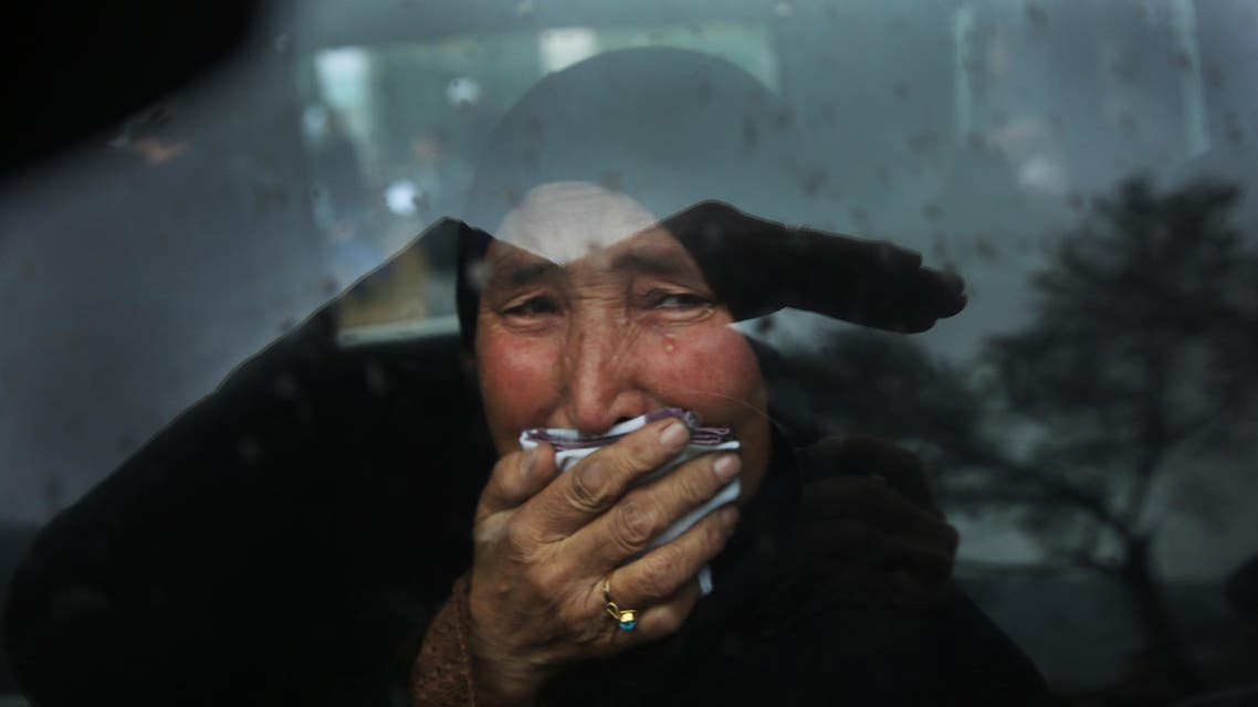A Hazara tribeswoman cries in a car as thousands march through the Afghan capital of Kabul on Wednesday, Nov. 11, 2015, carrying the coffins of seven ethnic Hazaras who were allegedly killed by the Taliban and calling for a new government that can ensure security in the country. (AP Photos/Massoud Hossaini)