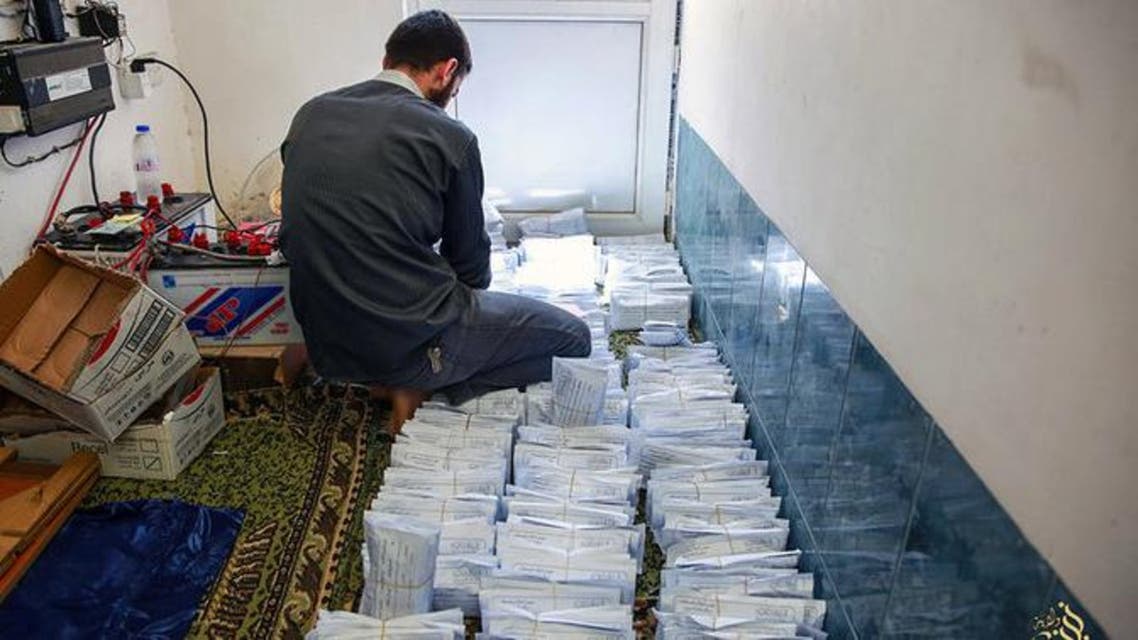 A photo from an ISIS website showed a member sorting envelopes of zakat (donations) collected from the rich to be distributed to the poor during the Muslim holy month of Ramadan in Mosul. (AP)