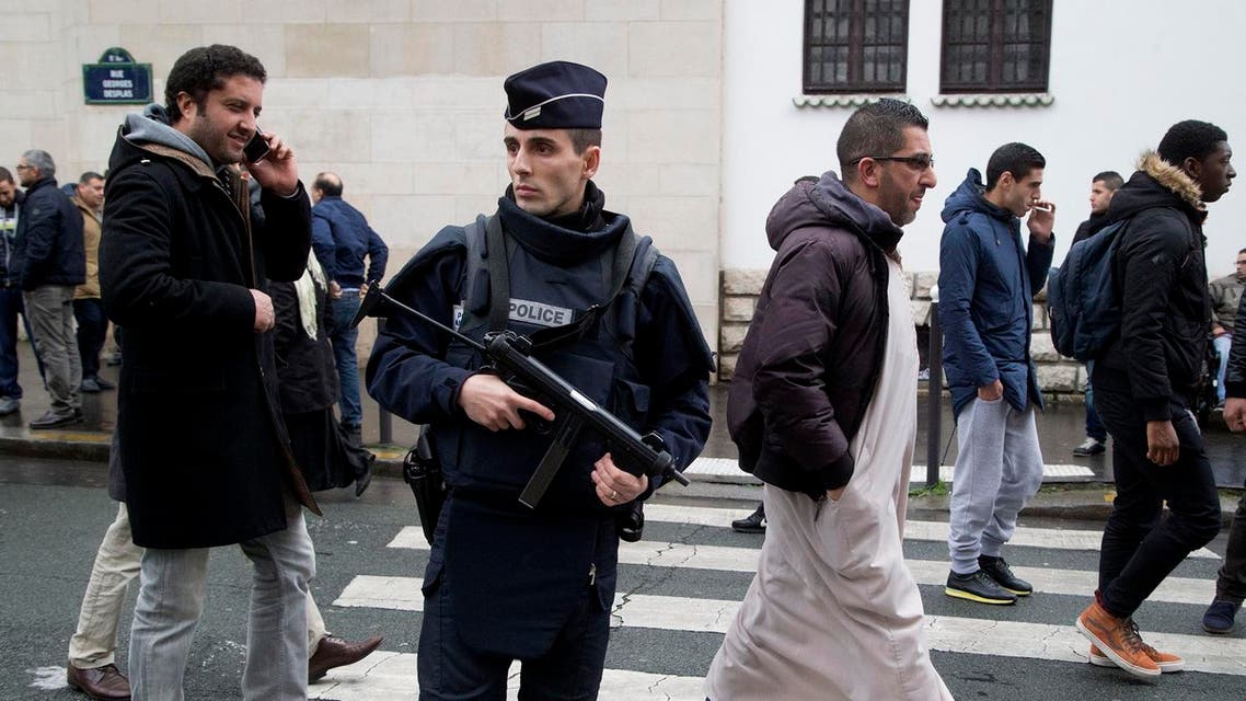 A French police officer stands guard outside the Grand Mosque in Paris, France, as Muslims arrive for Friday prayers, January 9, 2015. (AP)
