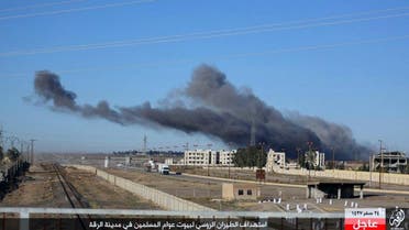 This image posted online Sunday, Dec. 6, 2015, by supporters of the Islamic State militant group on an anonymous photo sharing website, shows smoke rising in the aftermath of an airstrike that targeted areas in Raqqa, Syria. The photo bears the watermark of Islamic State media releases and is consistent with other AP reporting. The Arabic caption on the photo reads, "Russian warplanes target homes of Muslims in Raqqa.” (militant photo via AP)