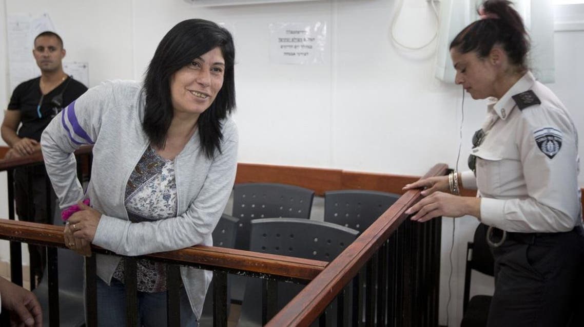 Palestinian Parliament member Khalida Jarrar of the Popular Front for the Liberation of Palestine (PFLP) attends a court session at the Israeli Ofer military base near the West Bank city of Ramallah, Thursday, May 21, 2015. An Israeli military court has ruled that Palestinian legislator Khalida Jarrar should be released on bail, but has ordered her held for at least three more days while the prosecutor decides whether to appeal. Jarrar, 52, was seized from her West Bank home in pre-dawn army raid on April 2. She has been charged with membership in a small leftist PLO faction banned by Israel and with inciting violence. (AP Photo/Majdi Mohammed)