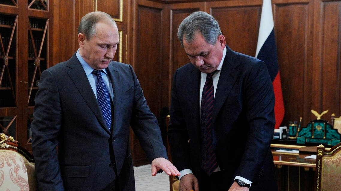 Russian President Vladimir Putin, left, and Defense Minister Sergei Shoigu, examine a flight recorder from the Russian warplane shot down by a Turkish jet on Nov. 24. (AP)