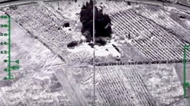 In this photo made from video footage provided by the Russian Defense Ministry on Wednesday, Dec. 9, 2015, a target is hit during an airstrike. Russia has unleashed another barrage of airstrikes against targets in Syria, including the first combat launch of a new cruise missile from a Russian submarine in the Mediterranean Sea, the country's defense minister said Tuesday. (Russian Defense Ministry Press Service via AP)