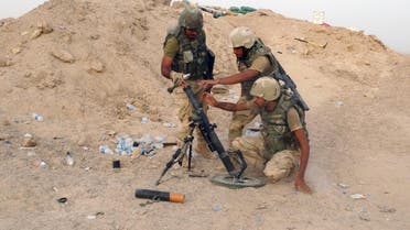 In this Thursday, Aug. 6, 2015 photo, Iraqi Army soldiers prepare to bomb Islamic State group positions at the front line in the eastern suburbs of Ramadi, Anbar province, Iraq.