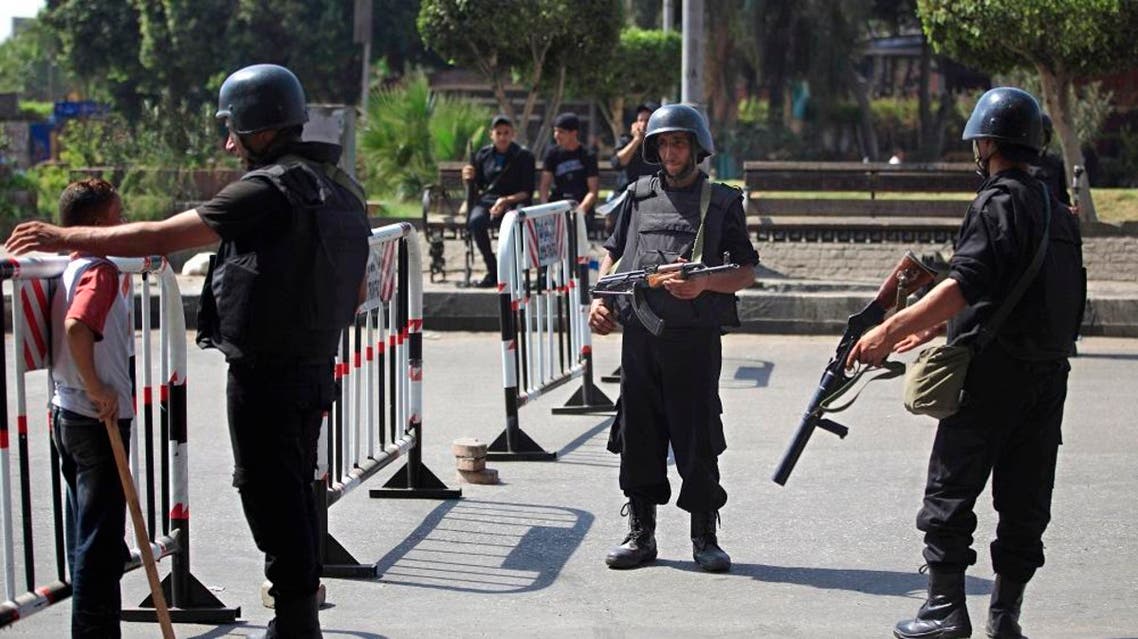 Egyptian police stand guard at an entrance to Sphinx Square in Cairo | AP
