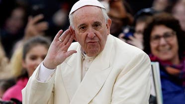 Pope Francis puts his hand to his ear to listen to a musical band playing as he arrives on his popemobile in St. Peter's Square for the weekly general audience, at the Vatican, Wednesday, Dec. 9, 2015. (AP Photo/Gregorio Borgia)