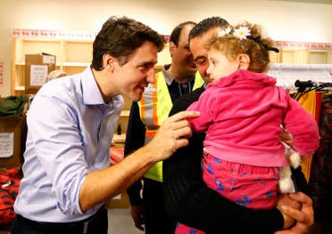 Syrian refugees are greeted by Canada's Prime Minister Justin Trudeau on their arrival from Beirut at the Toronto Pearson International Airport. (Reuters)