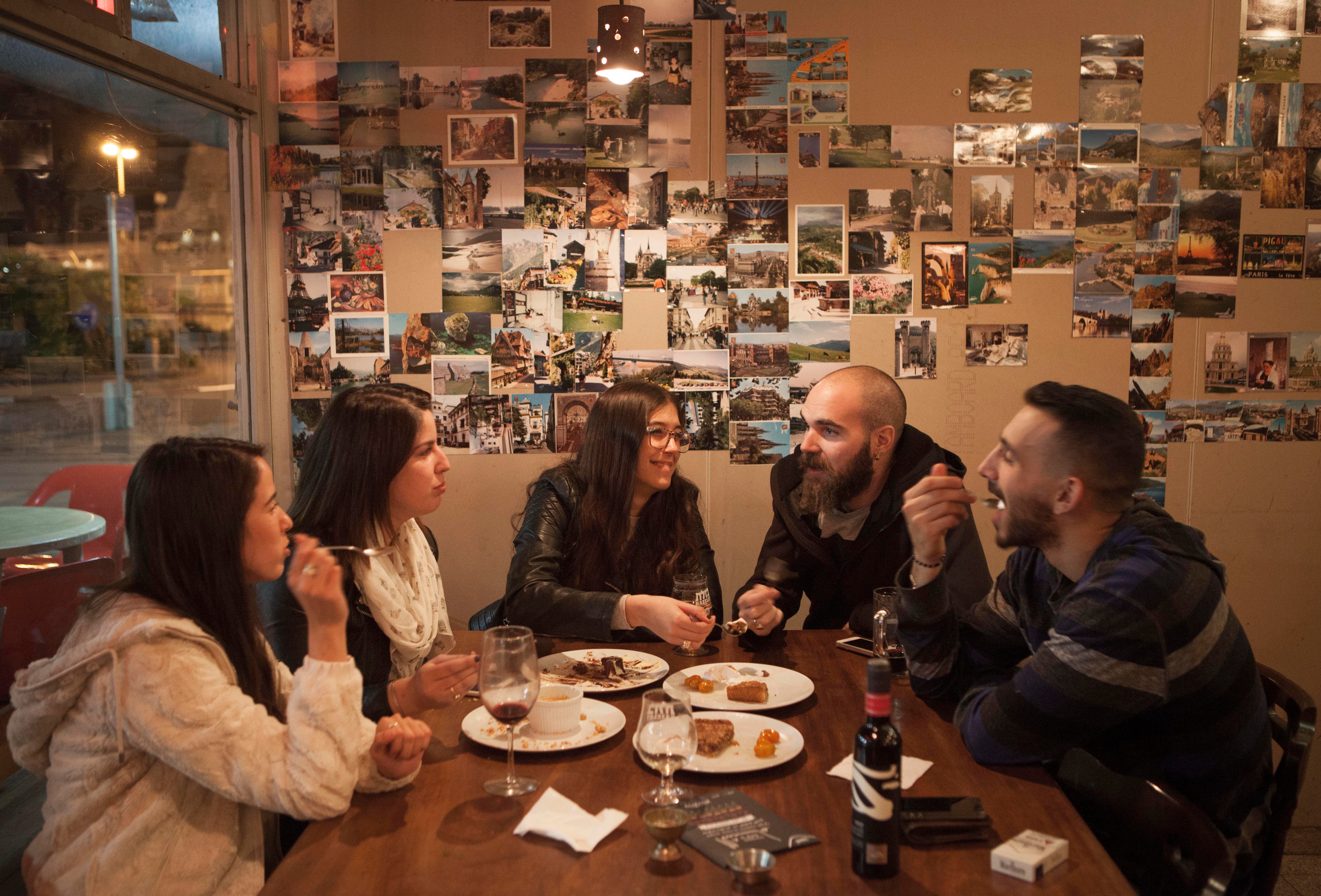 In this photo taken Tuesday, Dec. 8, 2015, Israelis enjoy a meal during an Arab Food Festival in Haifa, Israel. The festival featured about two dozen chefs from around Israel and east Jerusalem. (AP